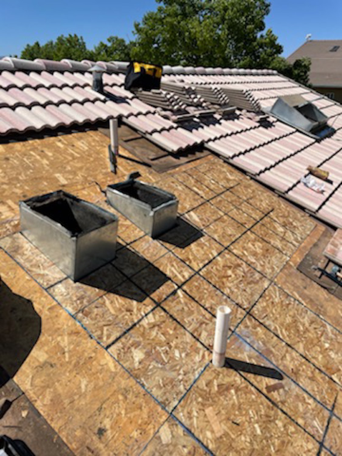 Tile roof tear-off with fresh decking and new flashing