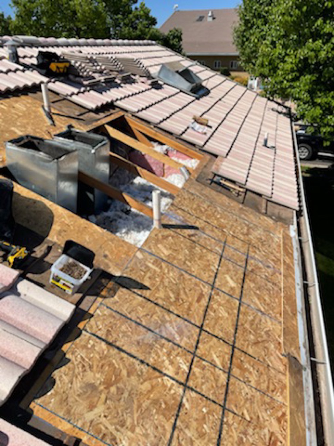 Re-roof in progress: decking down, tile being relaid