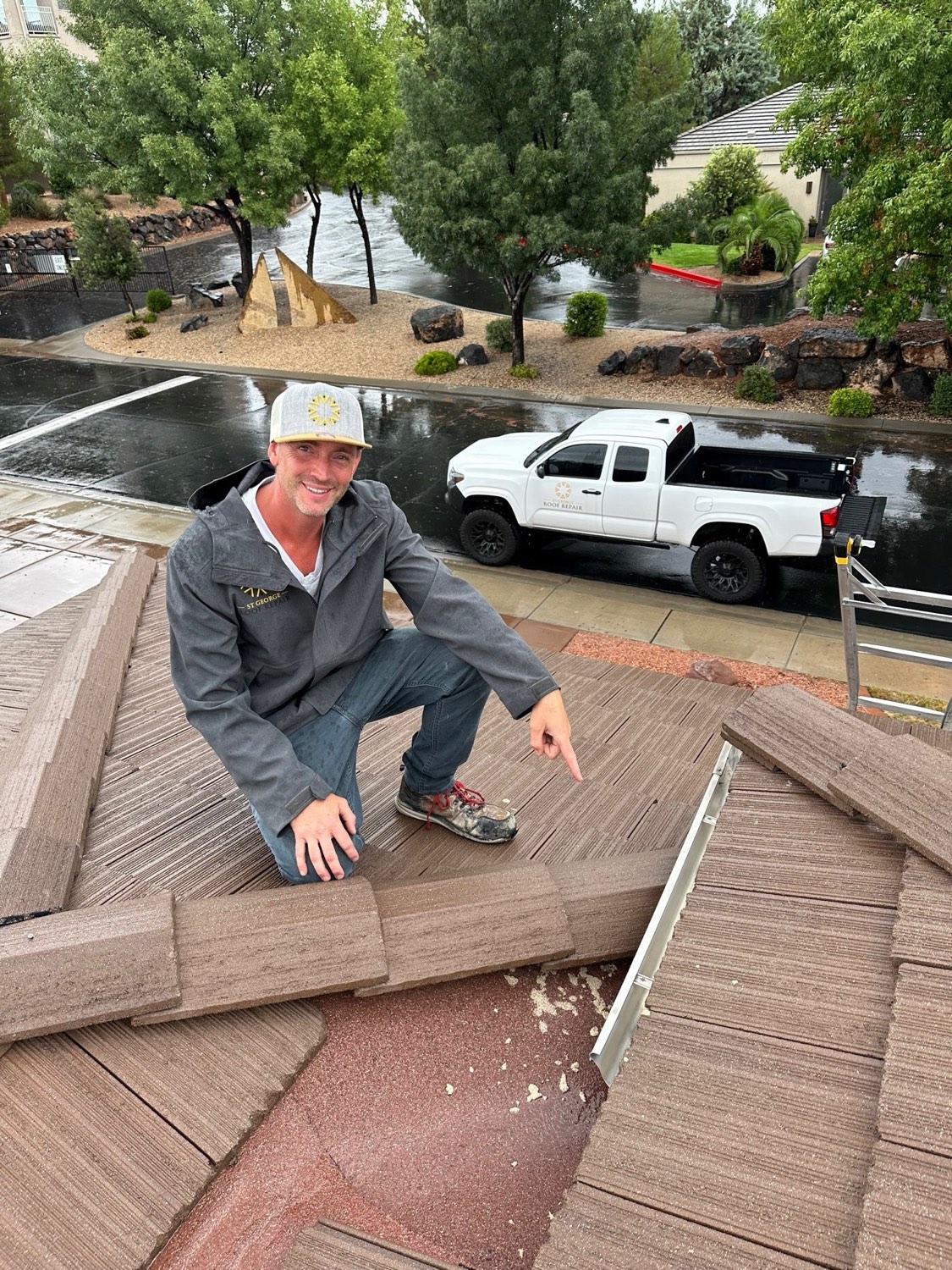 A St. George Roofing Pros tech inspecting a tile roof, truck parked on a rain-wet street